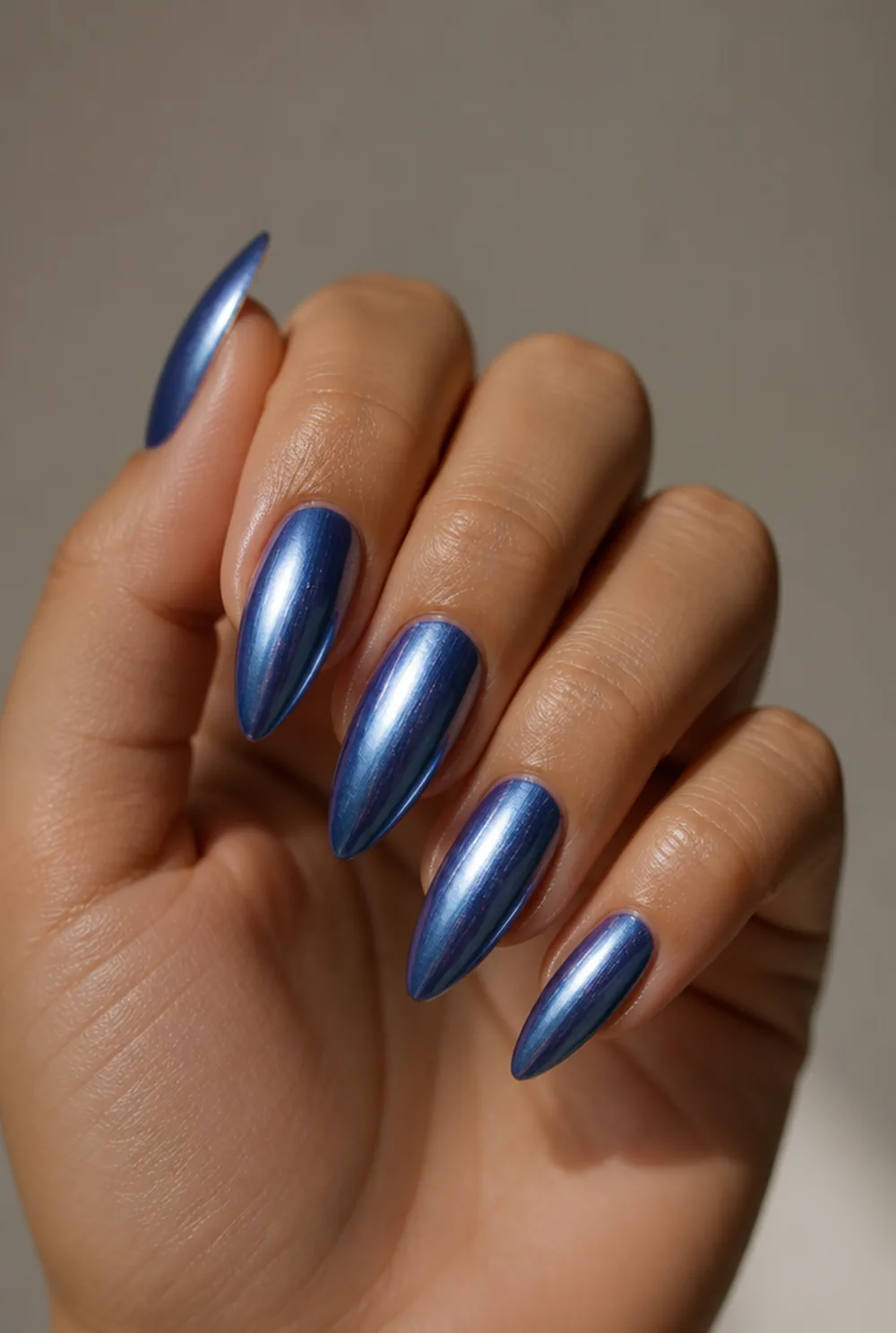 blue chrome mirror nail art on olive skin, long length