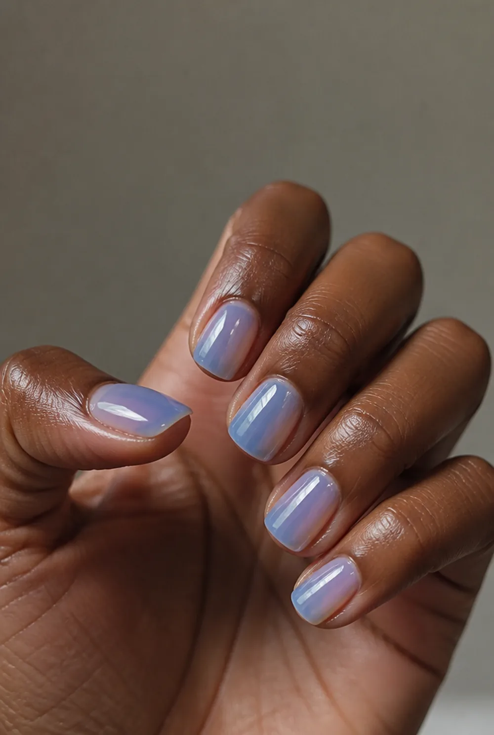 blue jelly nail art on deep brown skin
