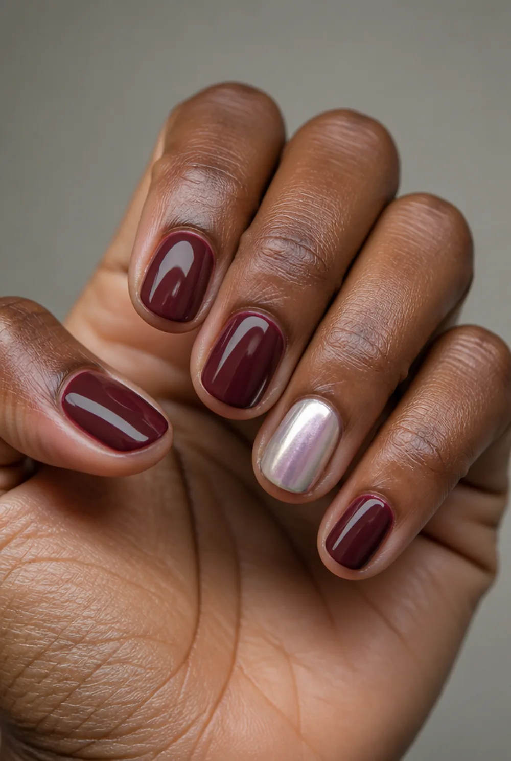 burgundy with pearl accent nail art on deep brown skin - PolishedAndPrettyNails.com burgundy with pearl accent nail art on deep brown skin