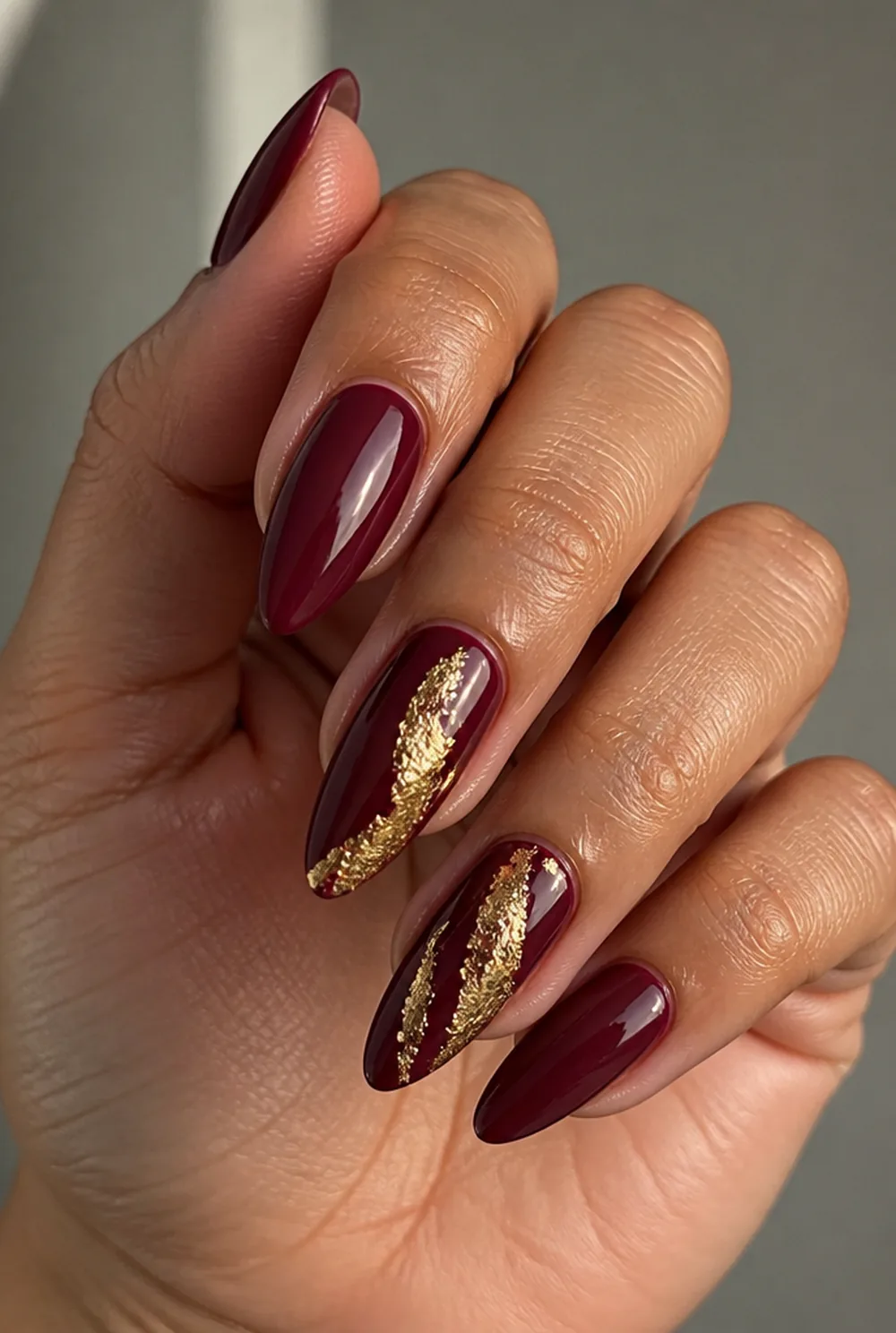 burgundy and gold foil nail art on olive skin long length - PolishedAndPrettyNails.com burgundy and gold foil nail art on olive skin, long length