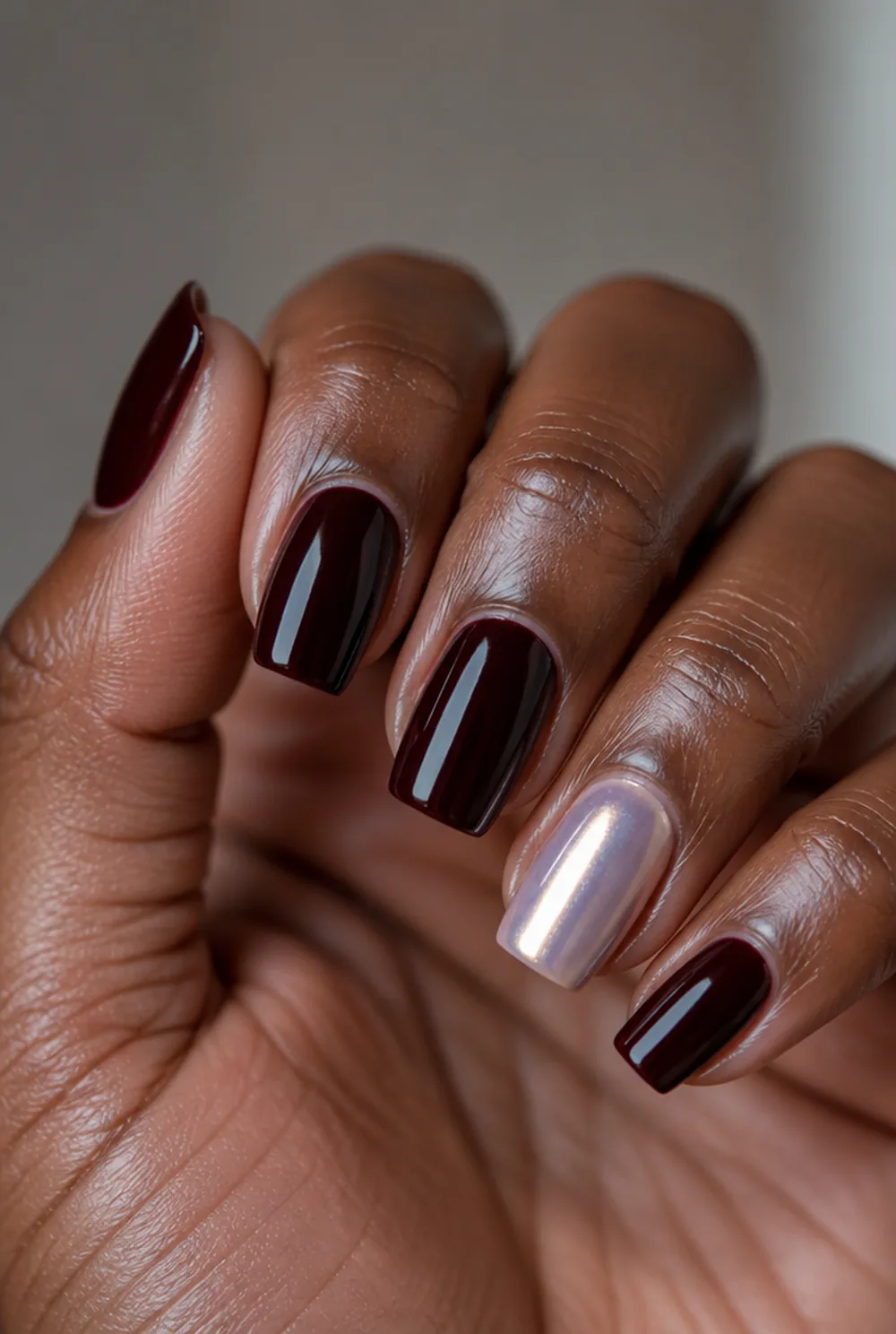 coffin with pearl accent nail art on deep brown skin