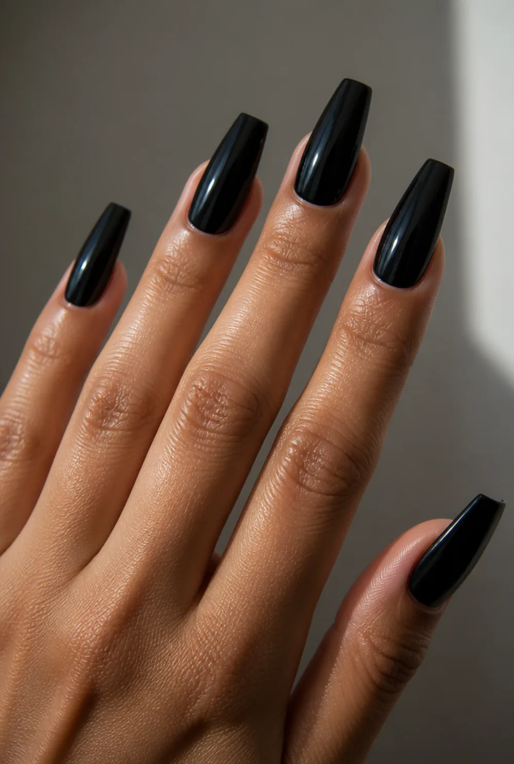 black coffin gloss nail art on olive skin, long length