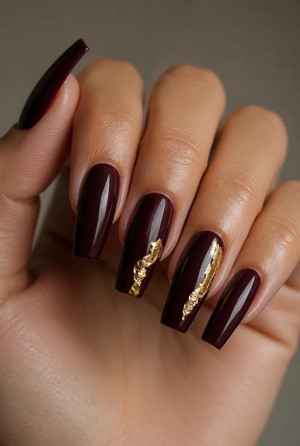 coffin with gold foil nail art on olive skin, long length