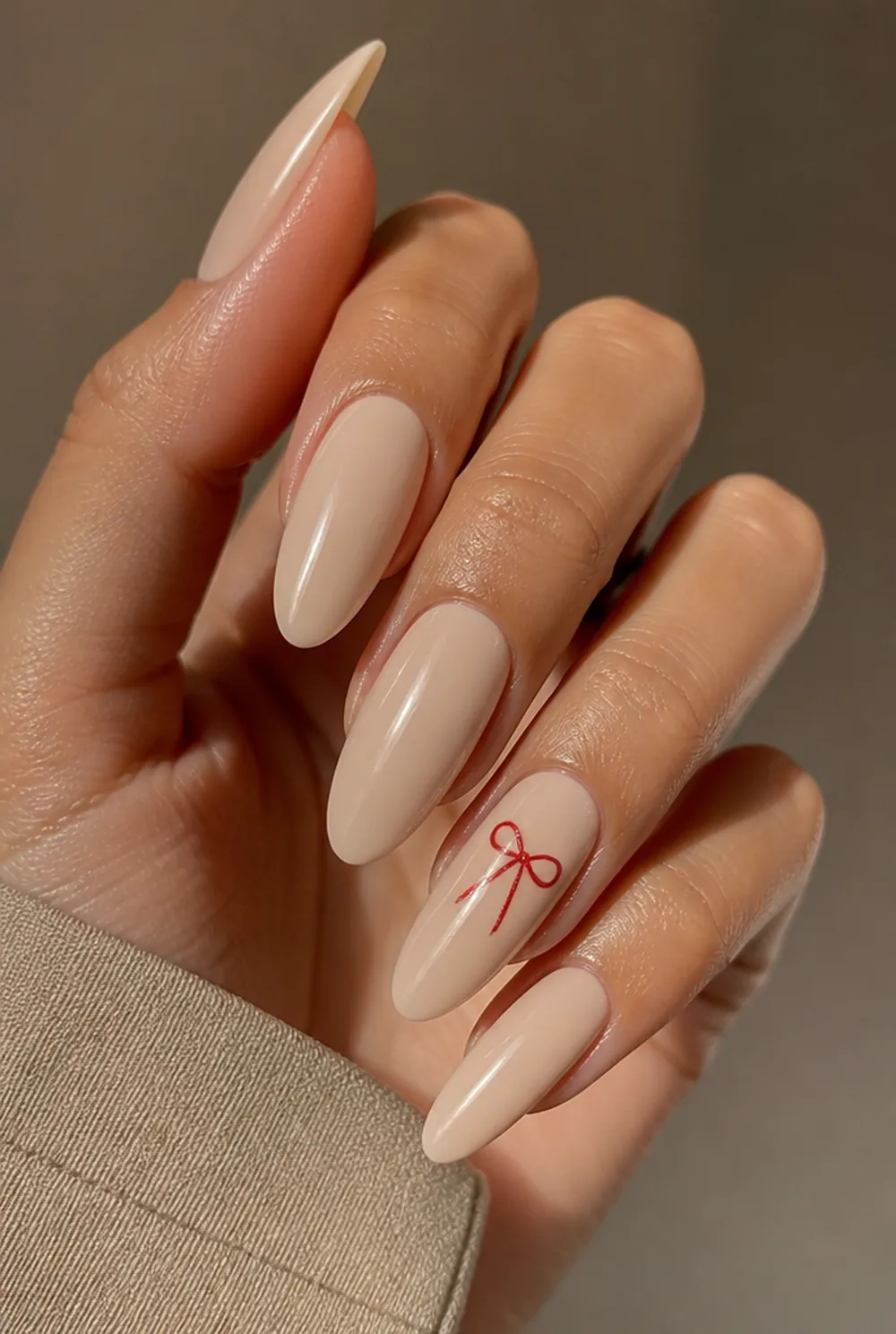 bow accent nail art on olive skin, long length