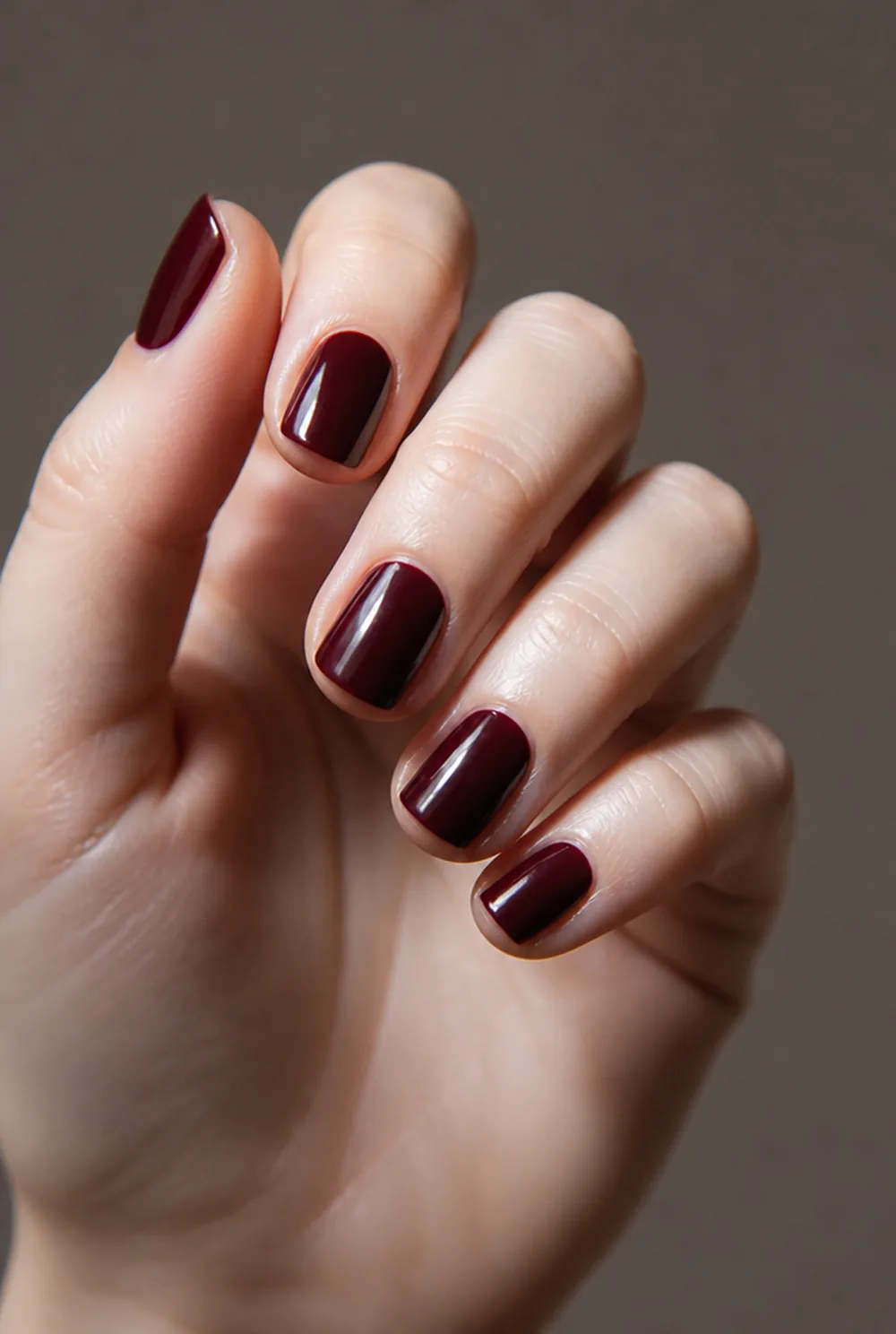 blackened cherry nail art on fair skin, short length