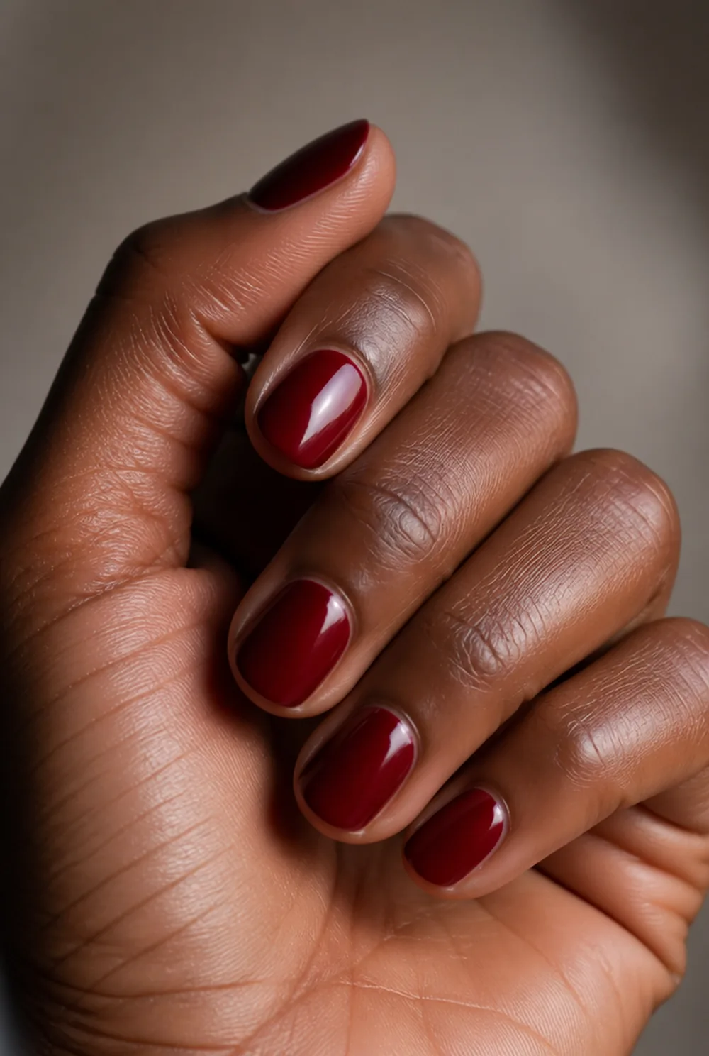 blackened cherry nail art on deep brown skin