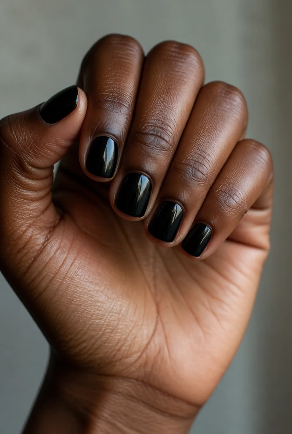 short black squoval nail art on deep brown skin
