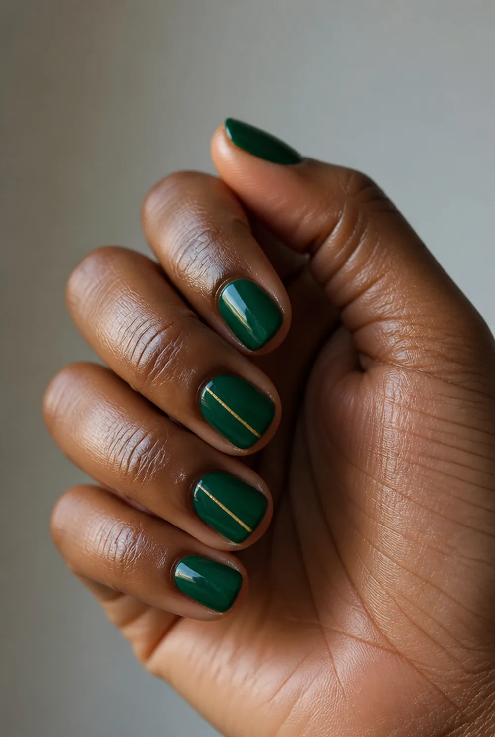 emerald and gold line nail art on deep brown skin - PolishedAndPrettyNails.com emerald and gold line nail art on deep brown skin
