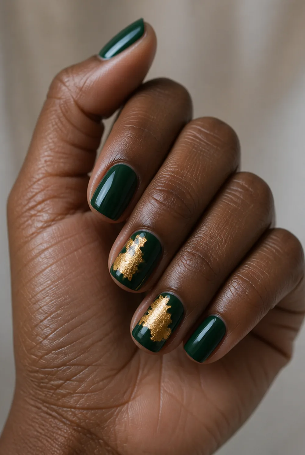 emerald with gold foil nail art on deep brown skin - PolishedAndPrettyNails.com emerald with gold foil nail art on deep brown skin