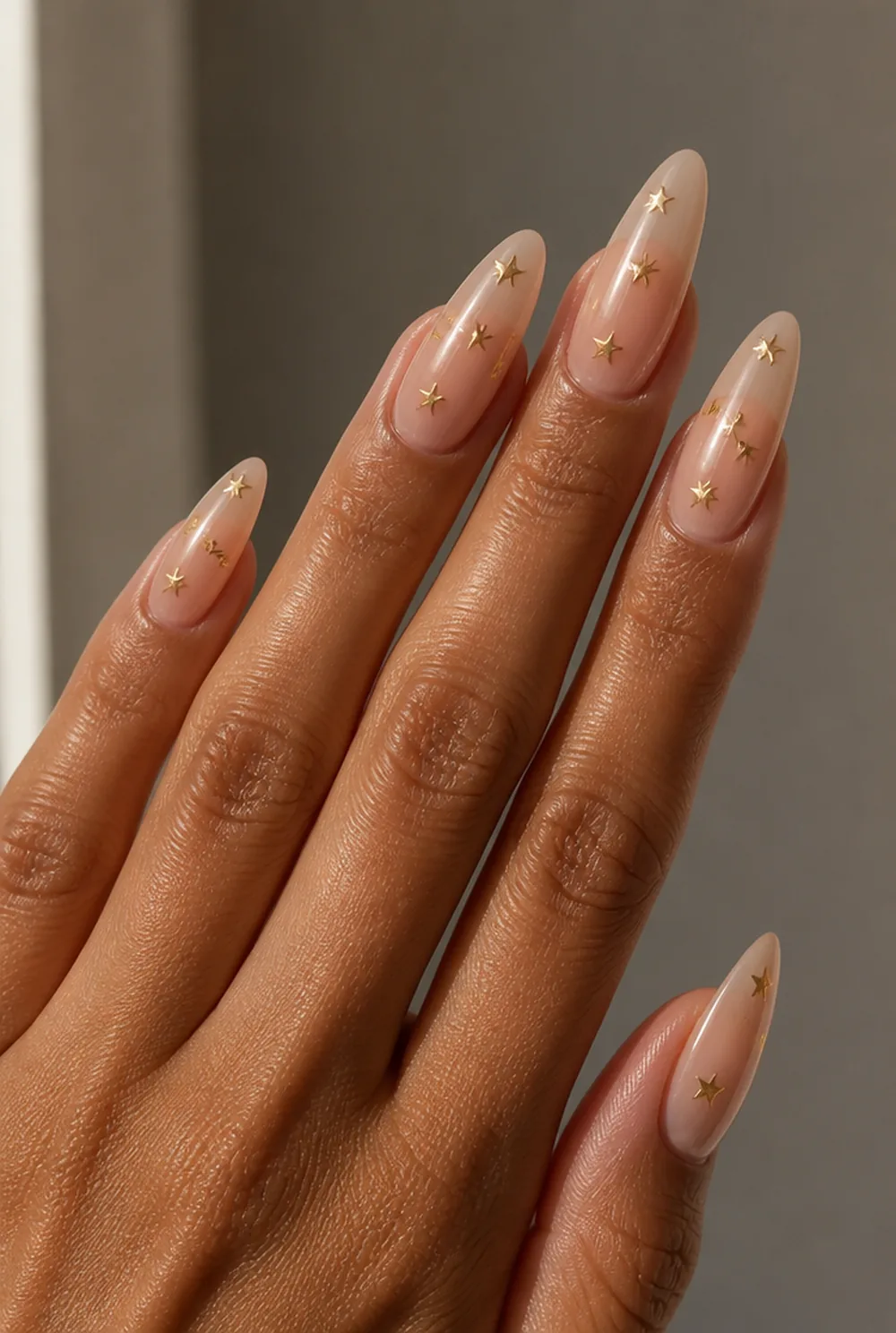 star confetti nail art on olive skin, long length