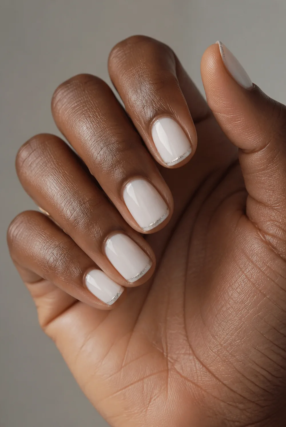 silver glitter tip nail art on deep brown skin