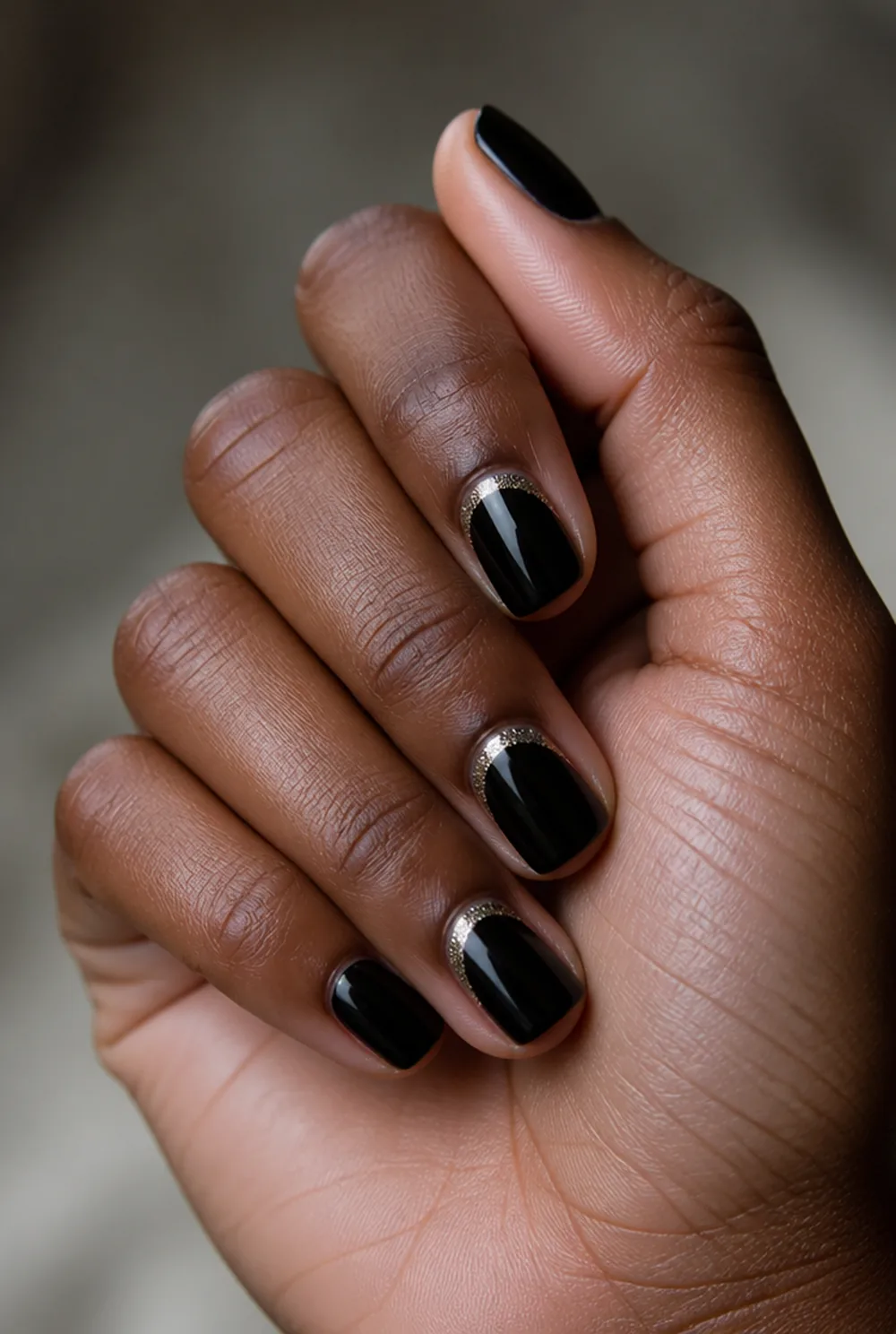 glitter half moon nail art on deep brown skin
