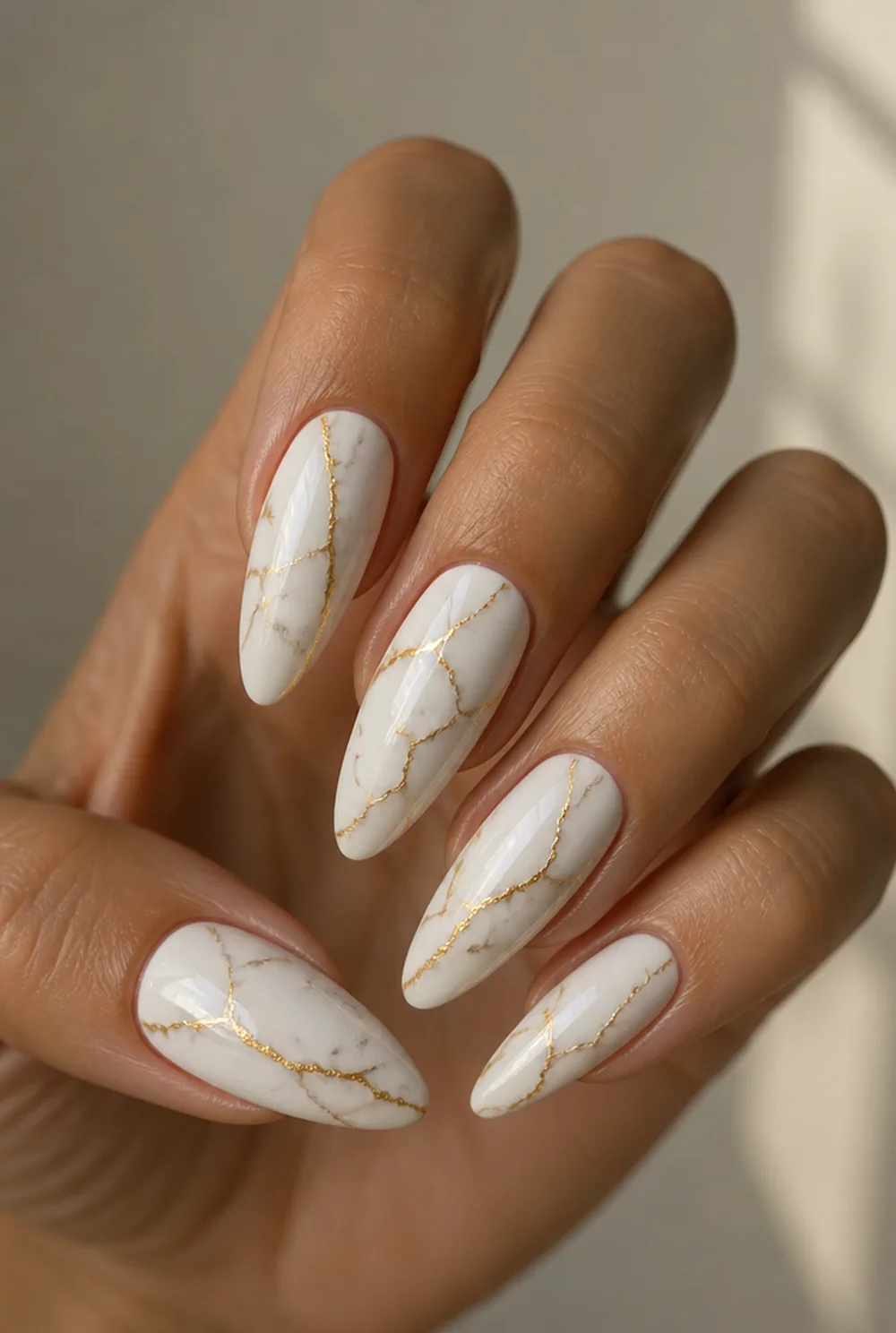 gold marble on white nail art on olive skin, long length
