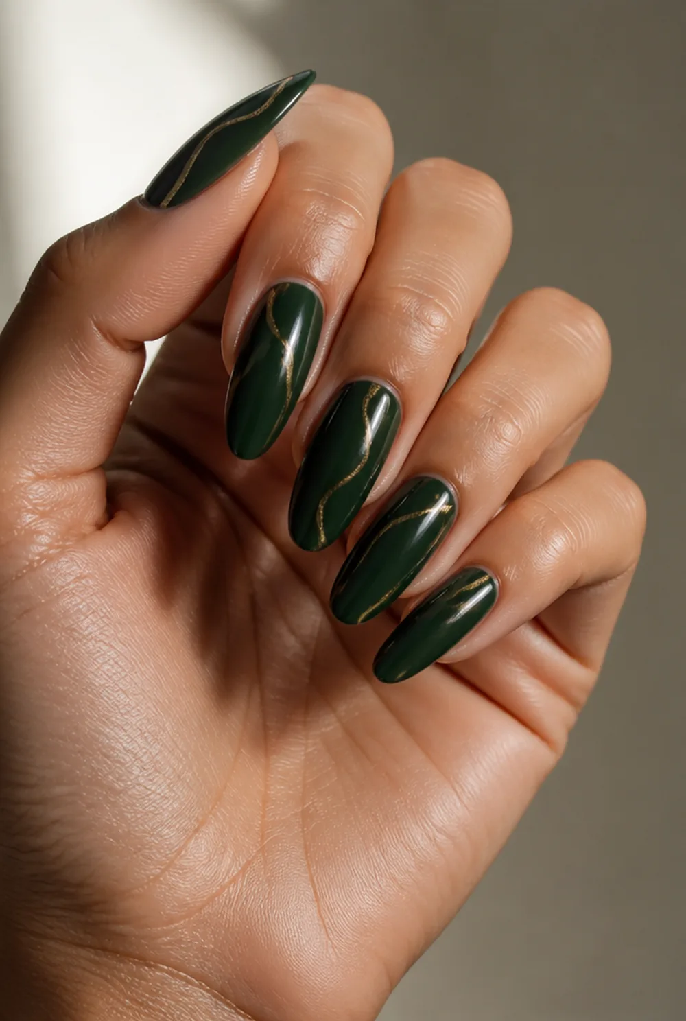 gold on emerald nail art on olive skin, long length