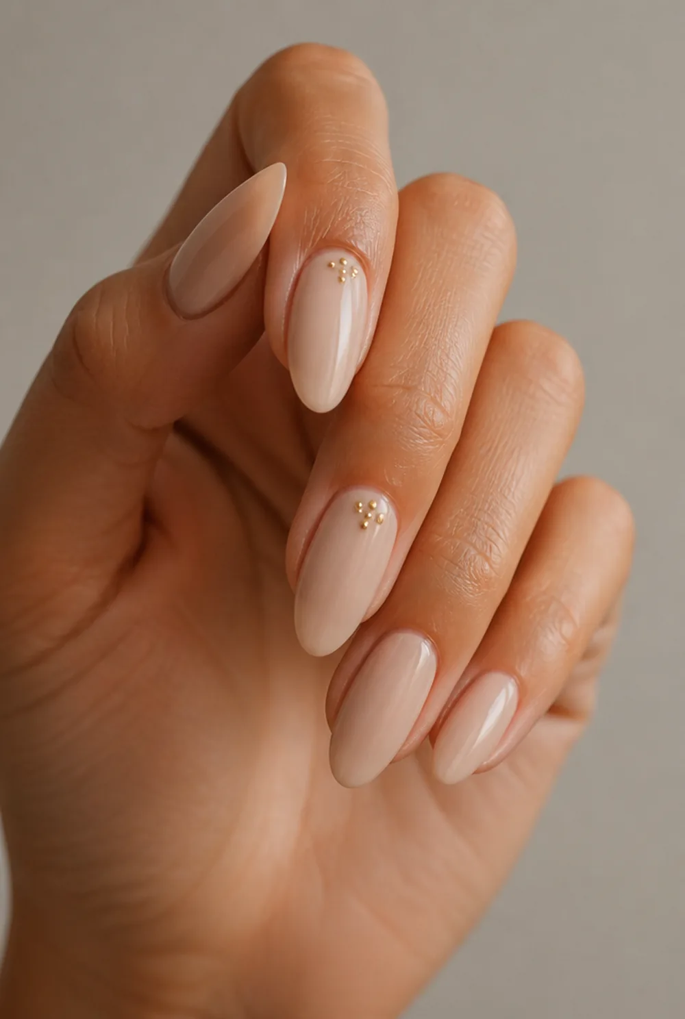 gold dot cluster nail art on olive skin, long length