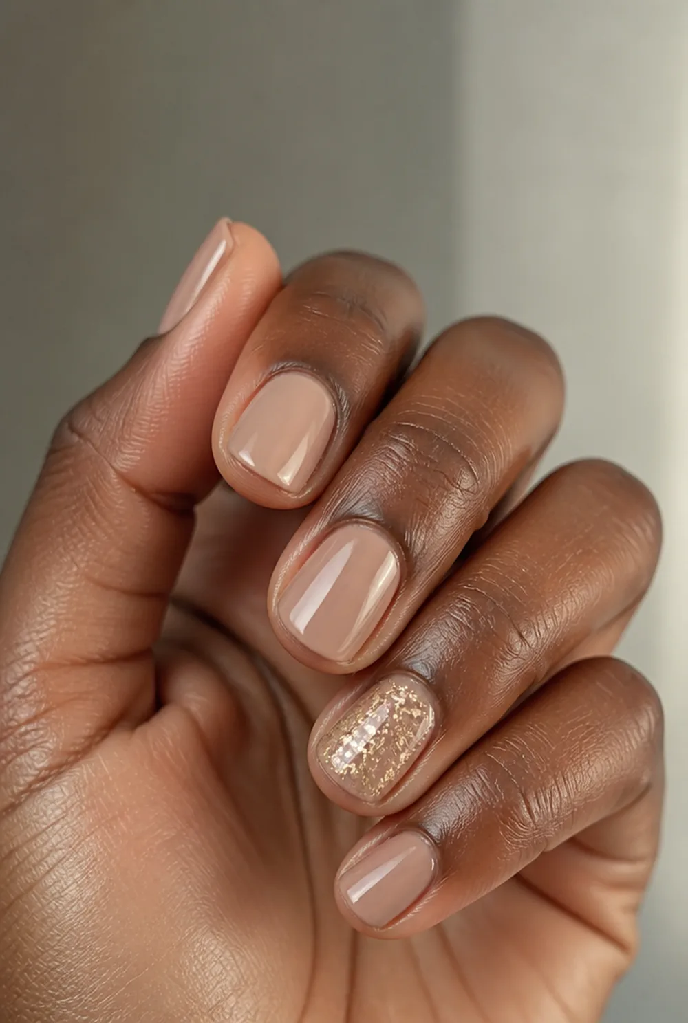 gold glitter accent nail nail art on deep brown skin
