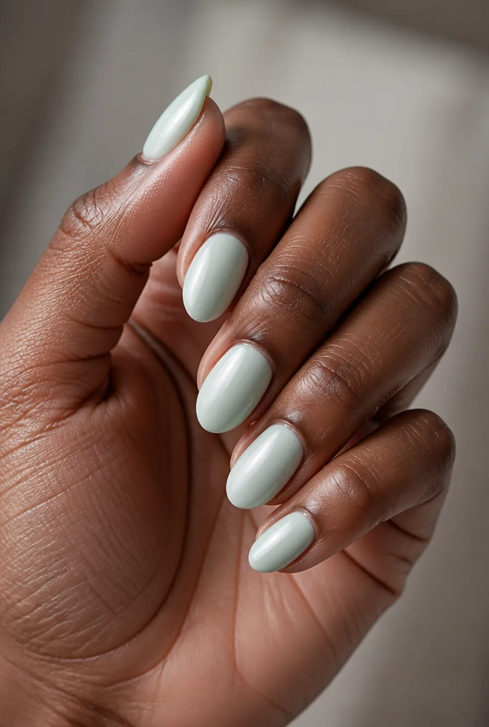 mint nail art on deep brown skin