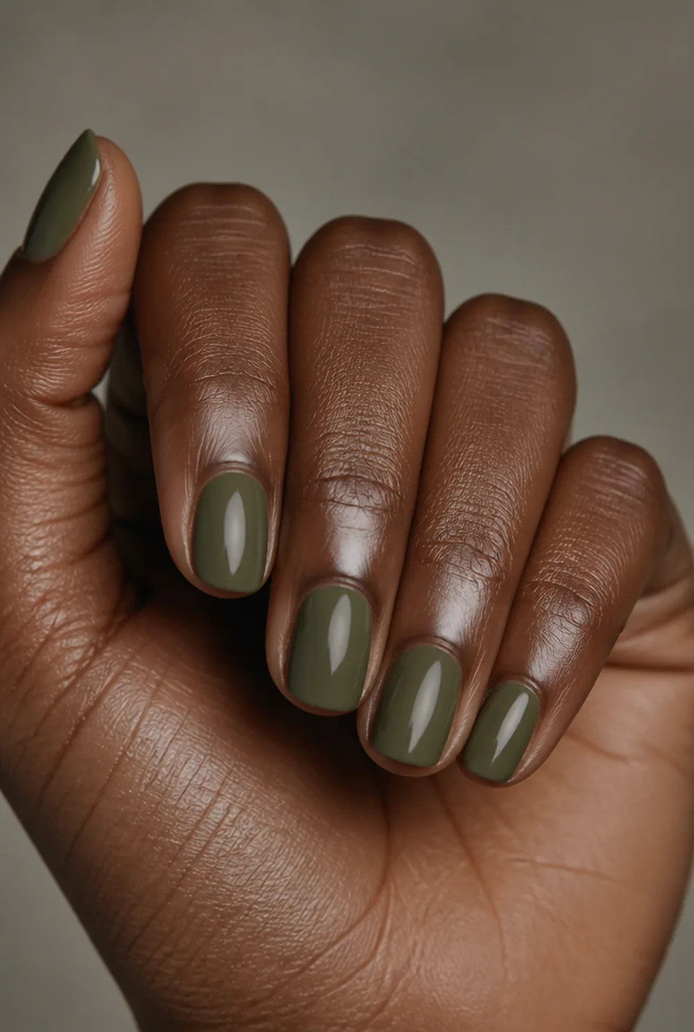 moss green nail art on deep brown skin