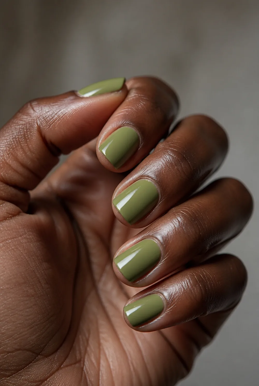 olive nail art on deep brown skin