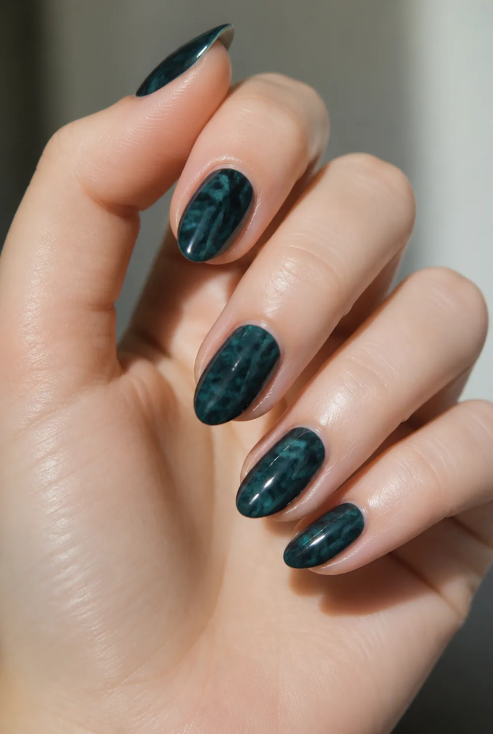 teal nail art on fair skin, short length