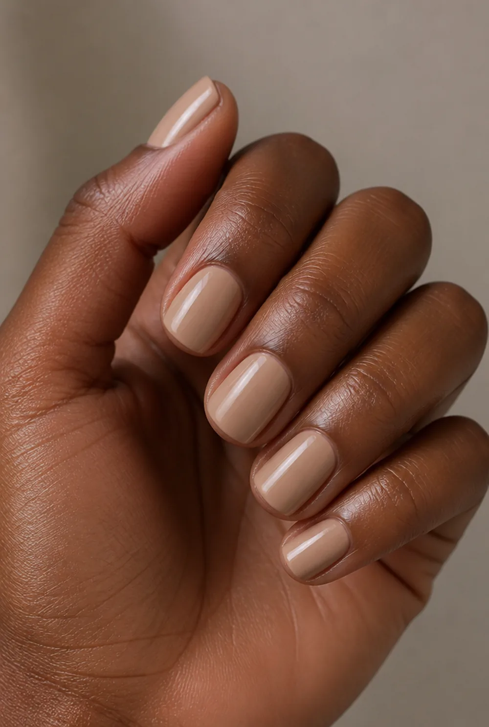matched nude nail art on deep brown skin