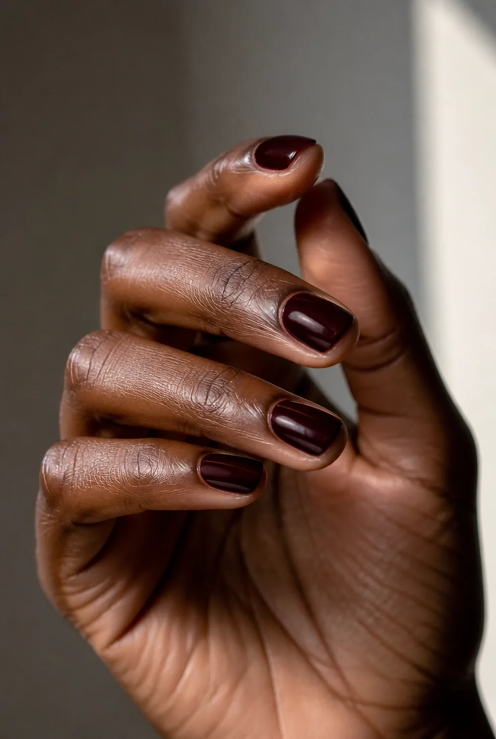 blackened cherry nail art on deep brown skin