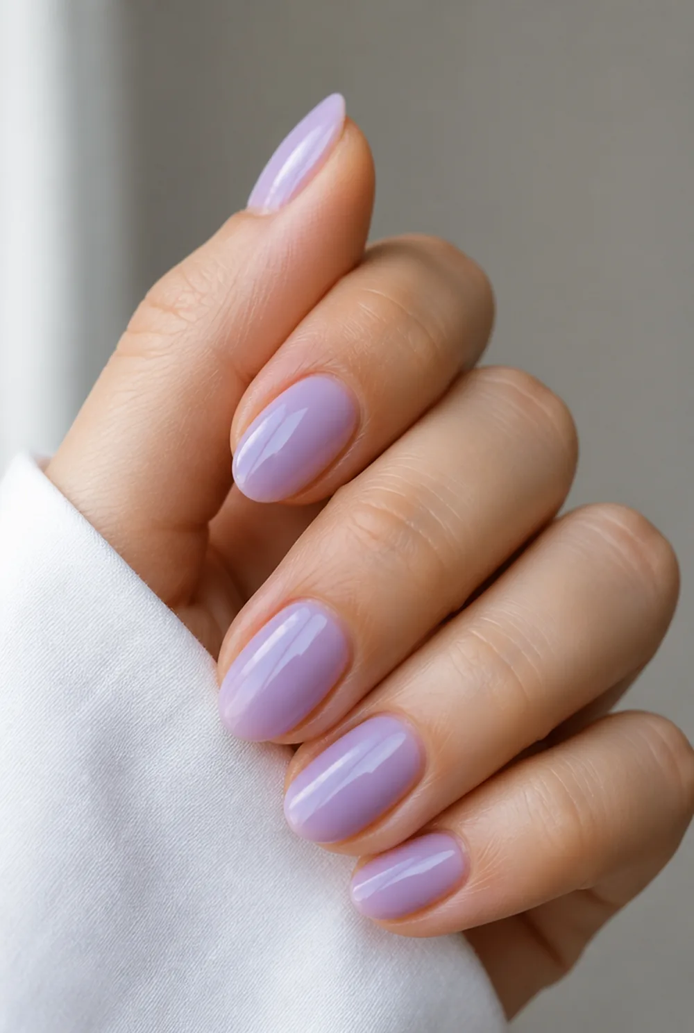 milky lilac nail art on fair skin, short length
