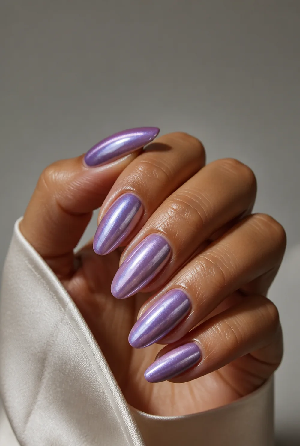 lavender cat eye nail art on olive skin, long length