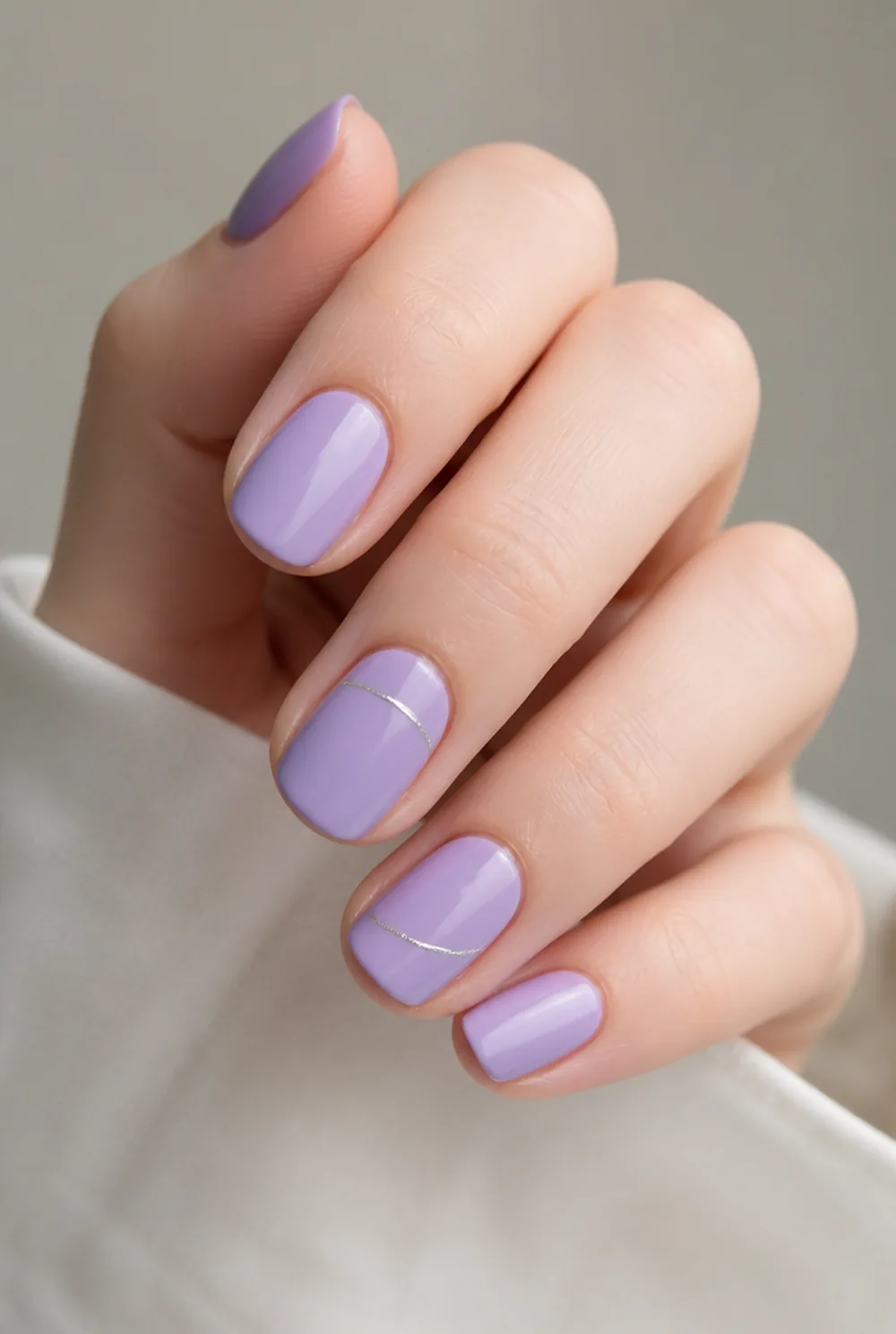 lavender and silver nail art on fair skin, short length