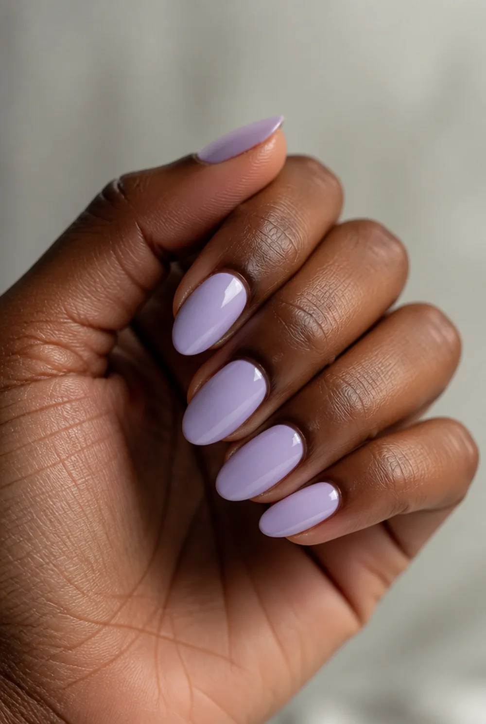 long lavender almond nail art on deep brown skin
