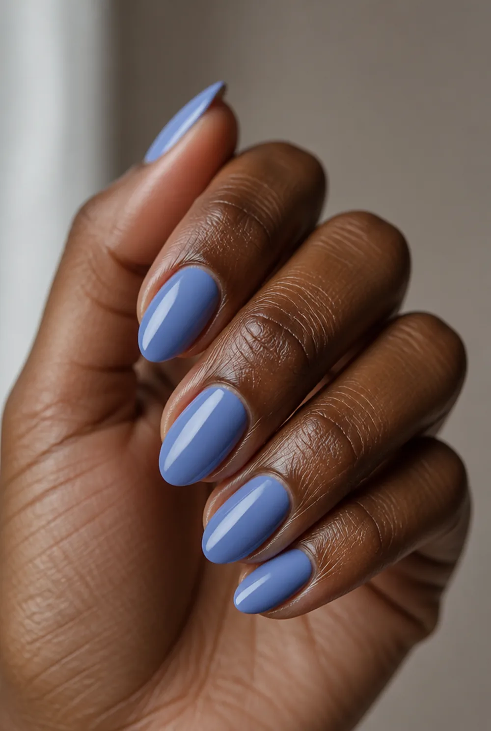 periwinkle nail art on deep brown skin