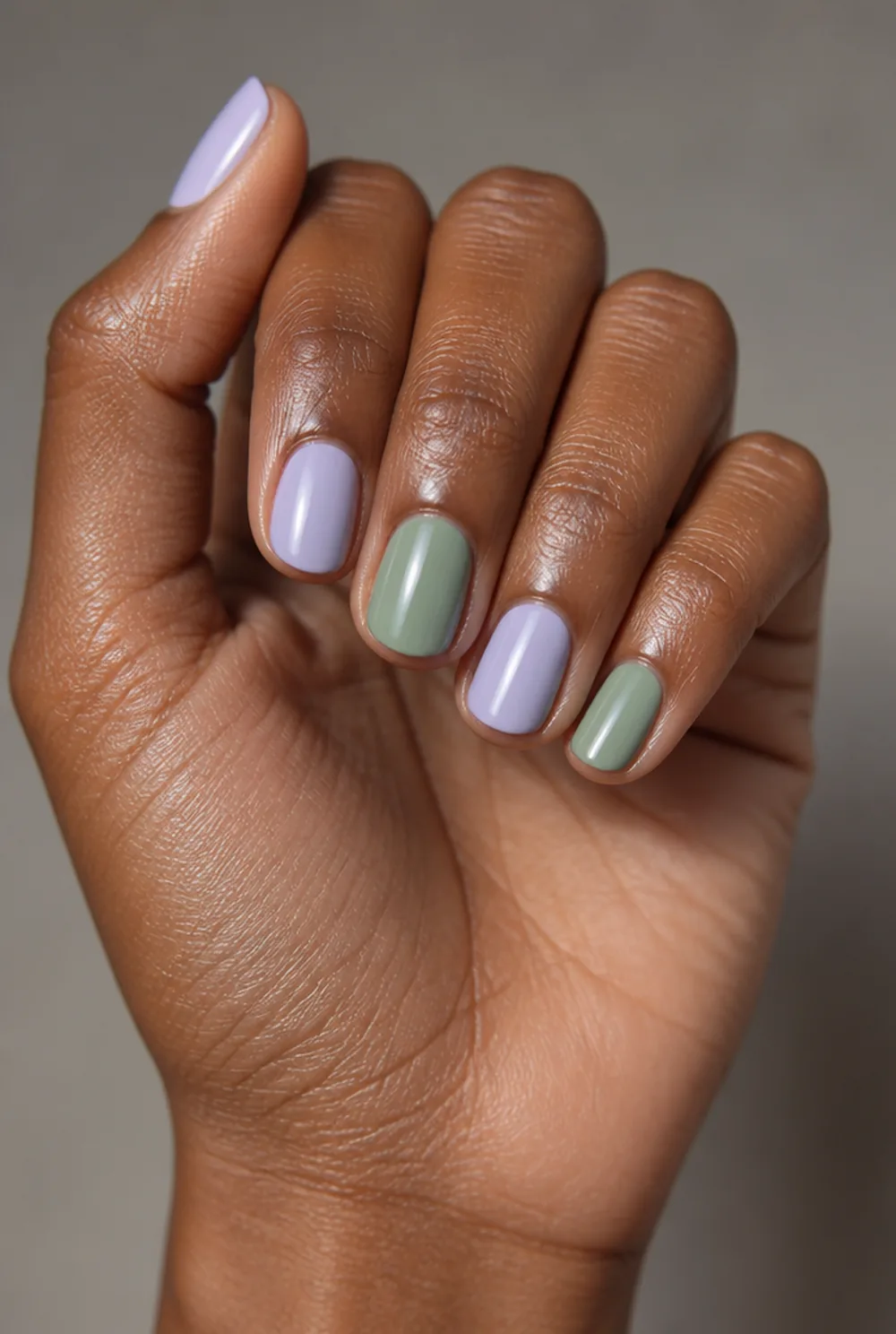 lavender and sage nail art on deep brown skin