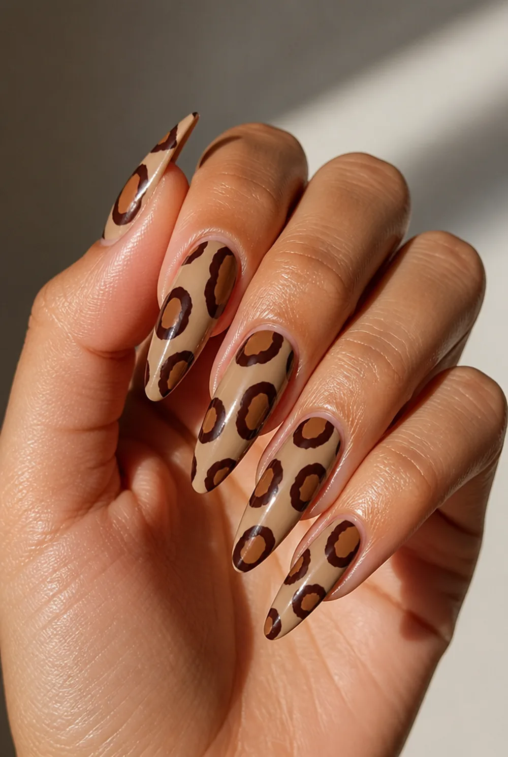 classic tan and brown nail art on olive skin, long length