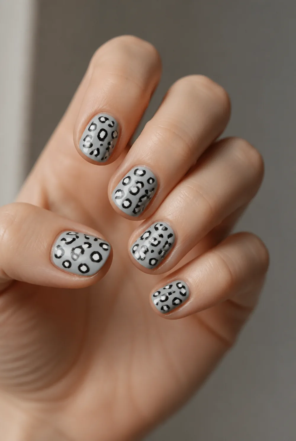 snow leopard nail art on fair skin, short length