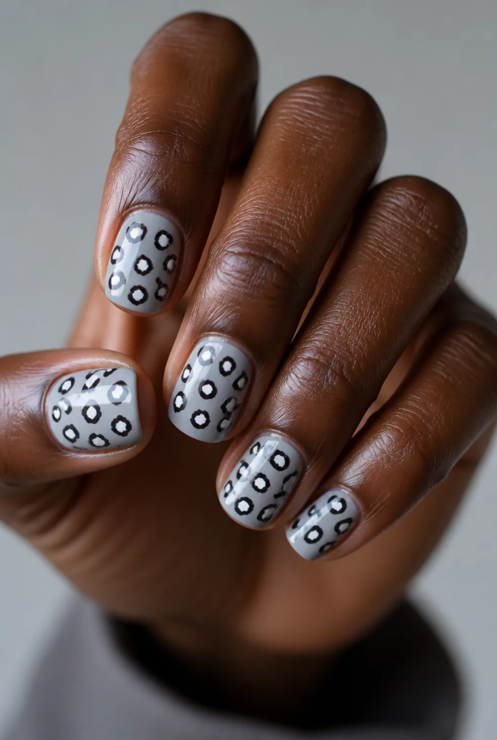 snow leopard nail art on deep brown skin