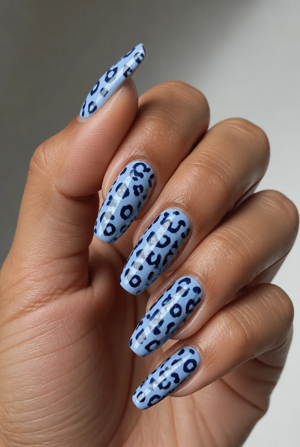 blue leopard nail art on olive skin, long length