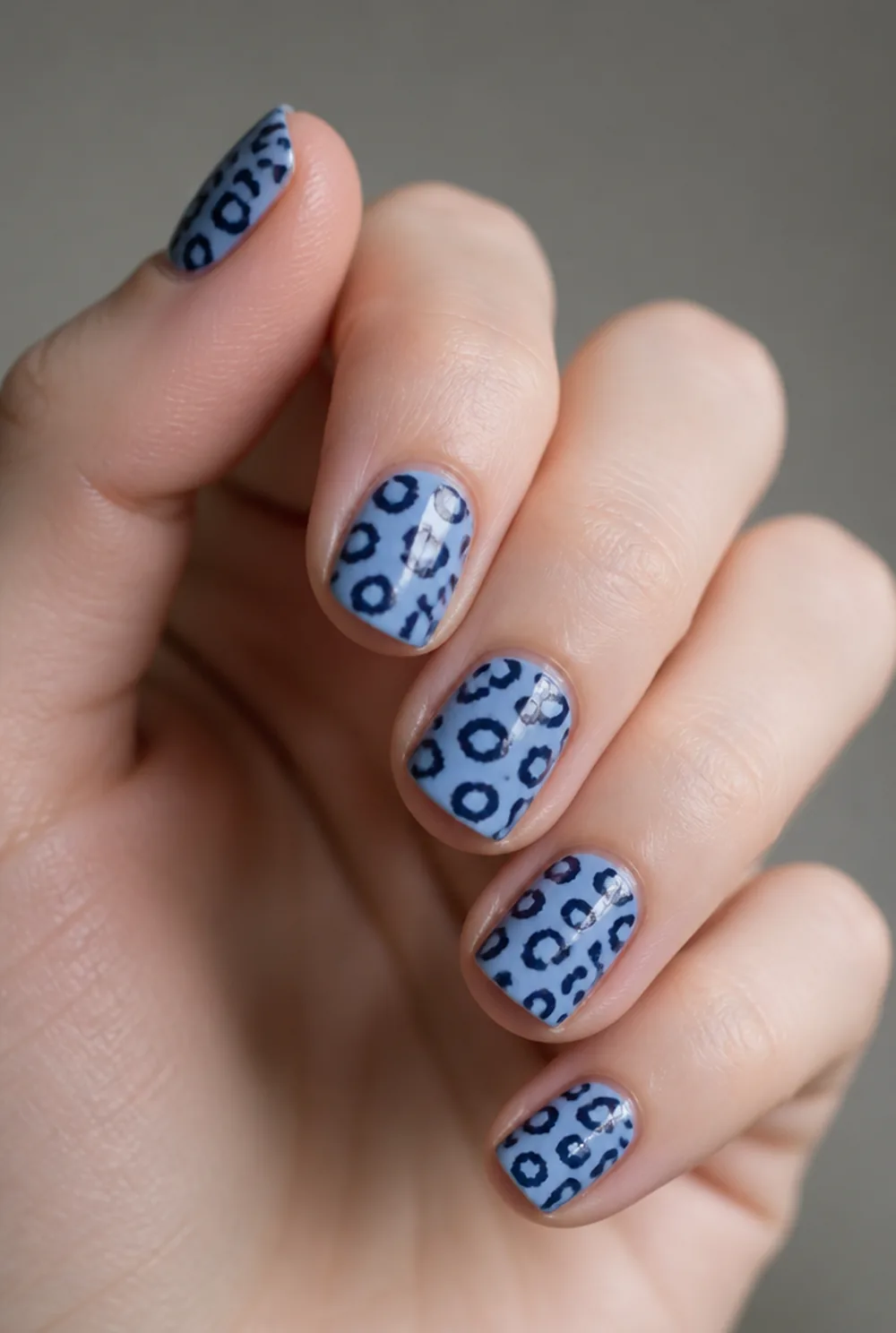blue leopard nail art on fair skin, short length