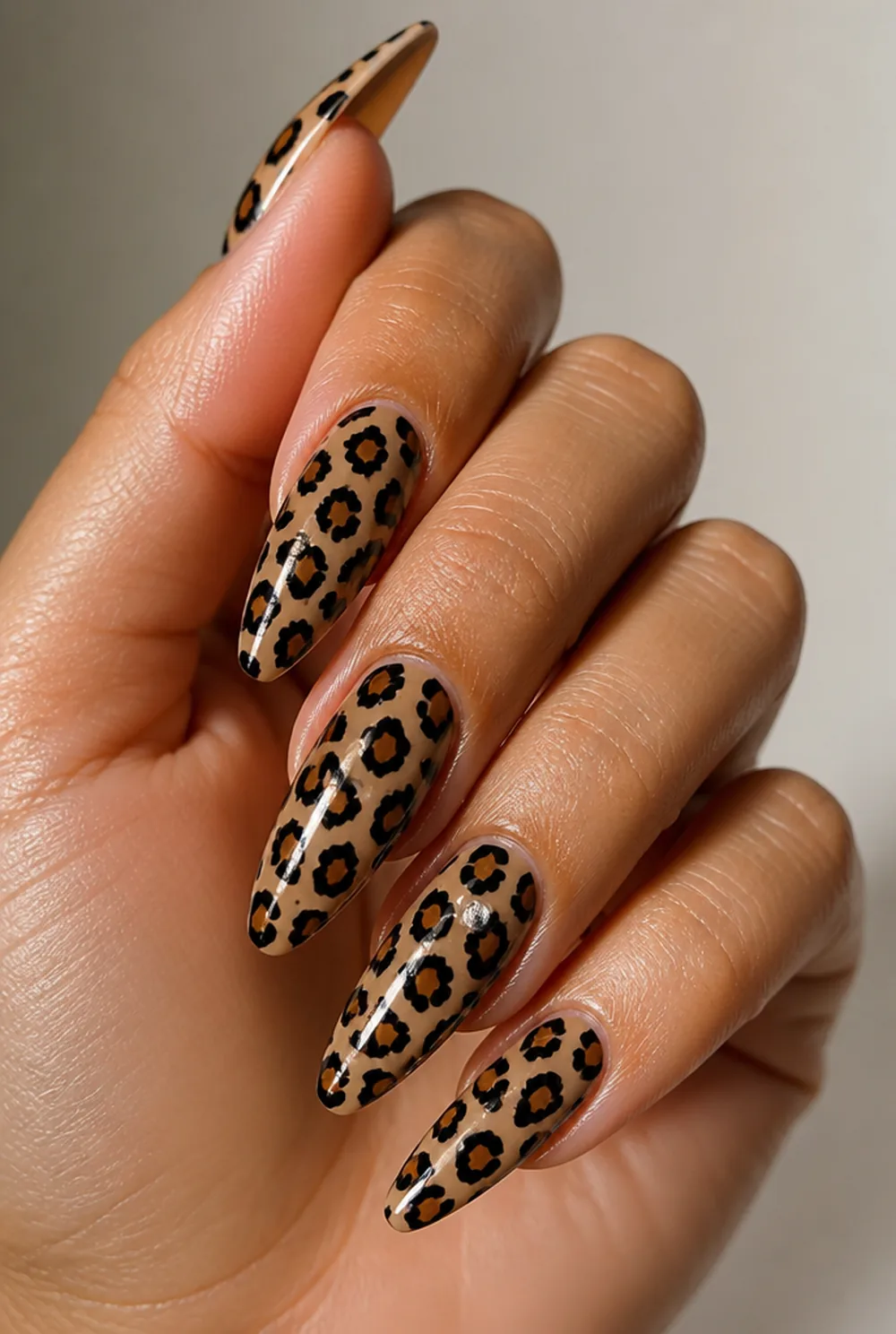 leopard with rhinestone nail art on olive skin, long length