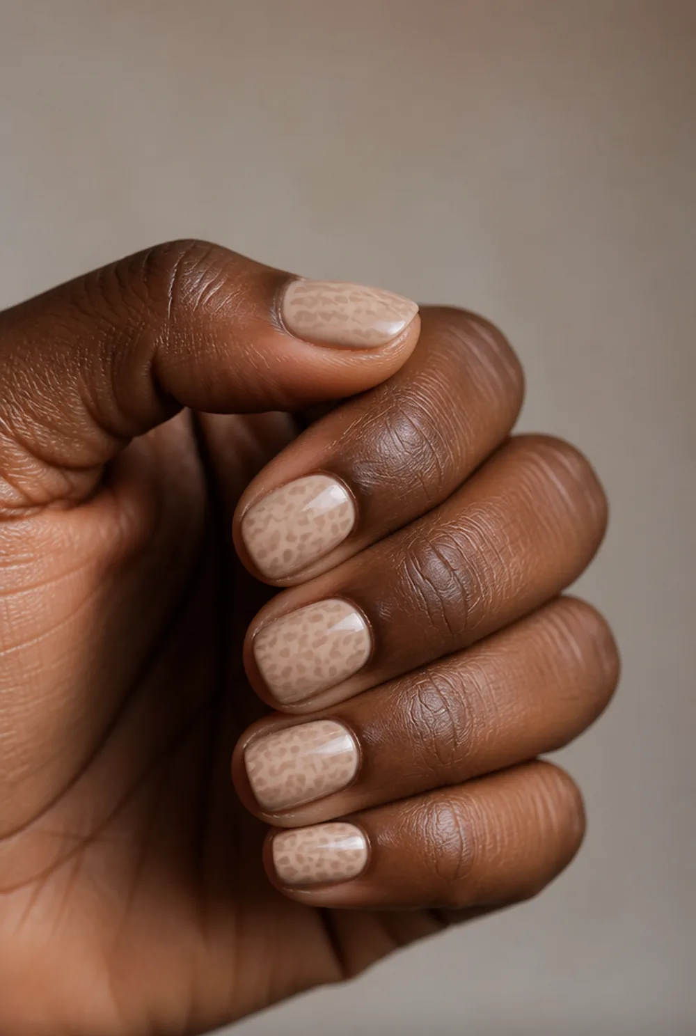 neutral leopard nail art on deep brown skin