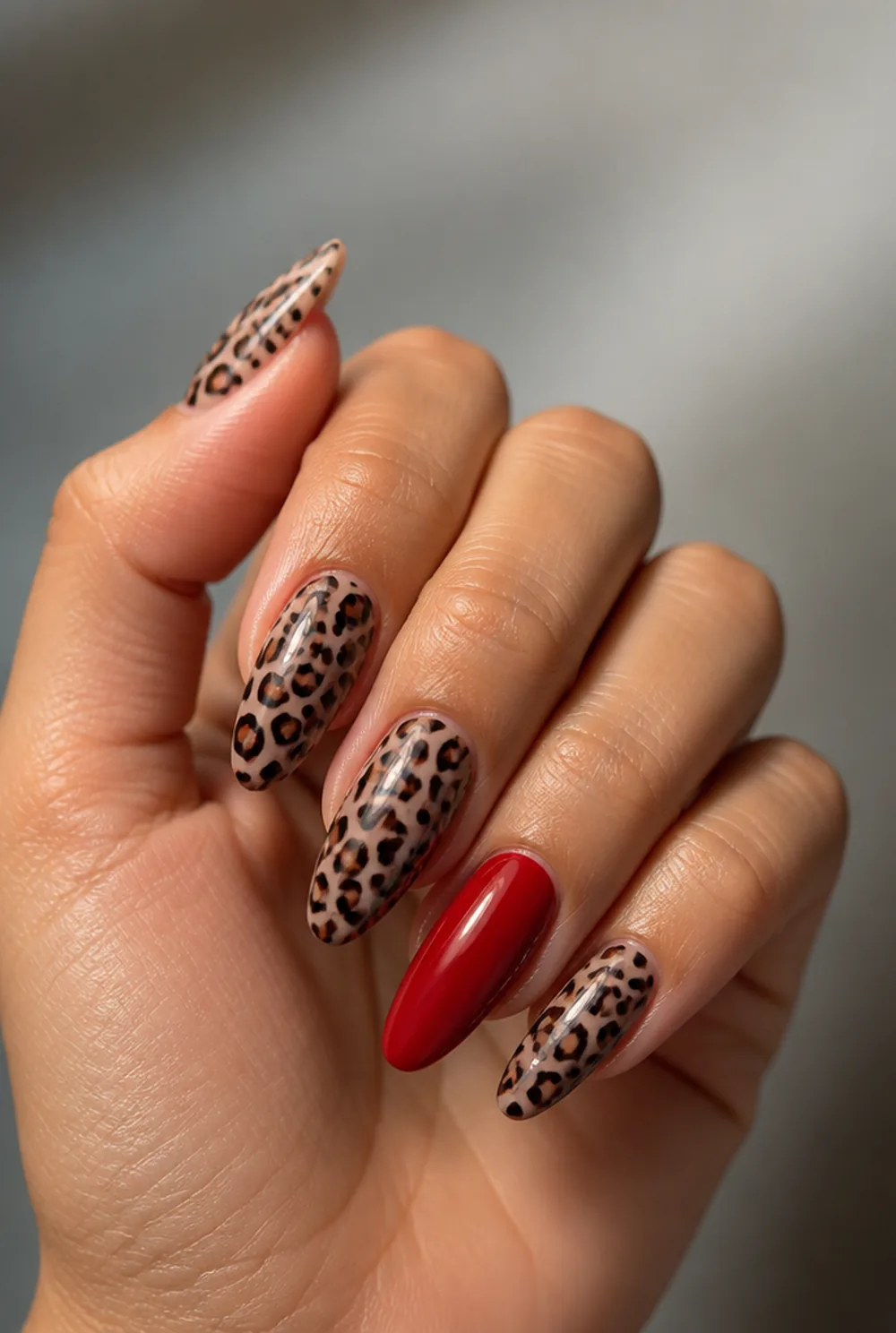 leopard with red nail art on olive skin, long length