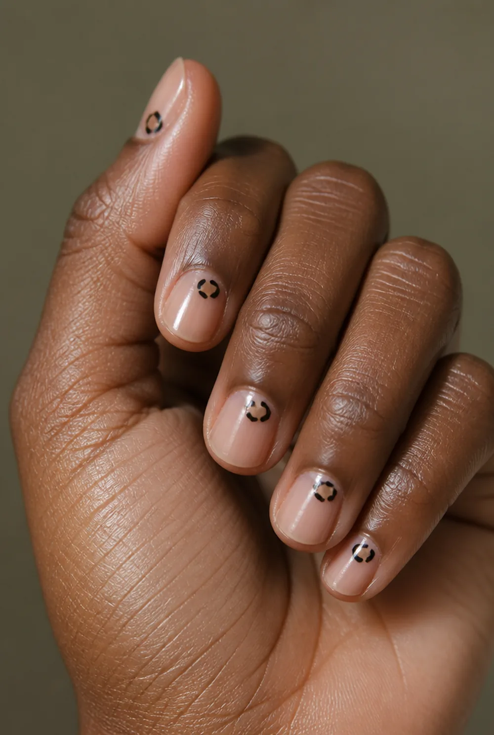 single spot accent nail art on deep brown skin