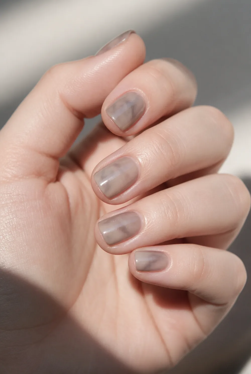 smoke marble nail art on fair skin, short length