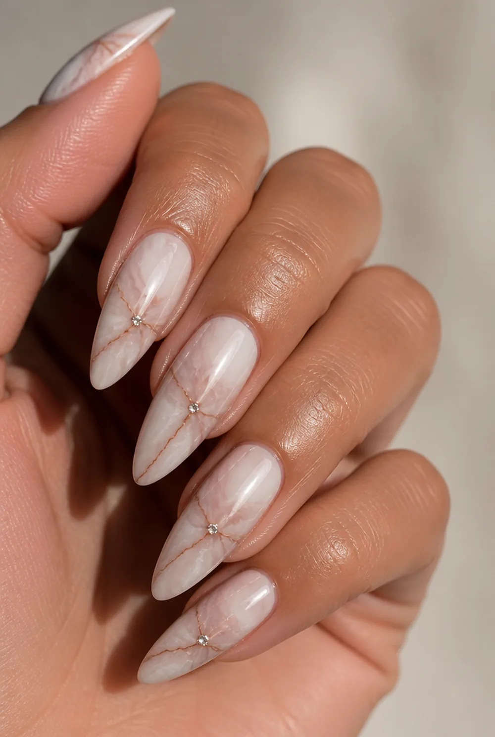 marble with rhinestone nail art on olive skin, long length
