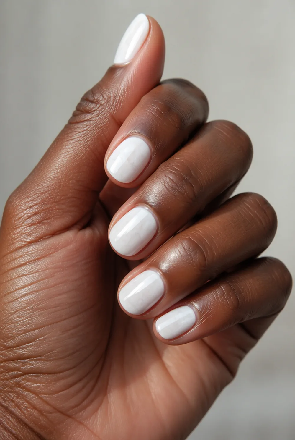 milky alabaster nail art on deep brown skin