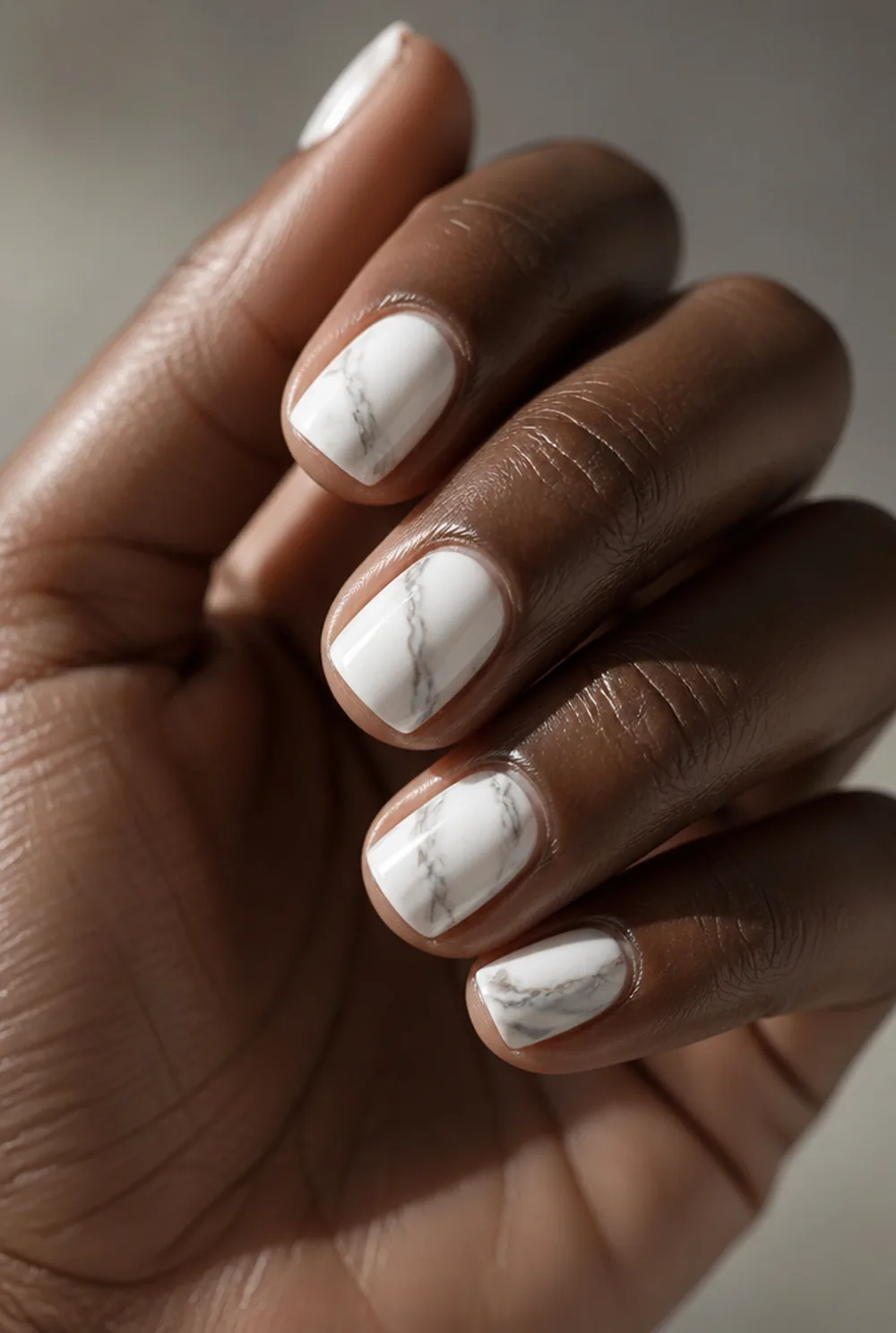 marble on short square nail art on deep brown skin
