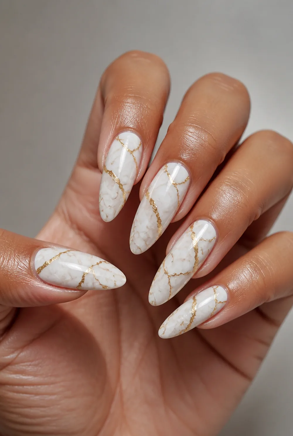 gold vein marble nail art on olive skin, long length