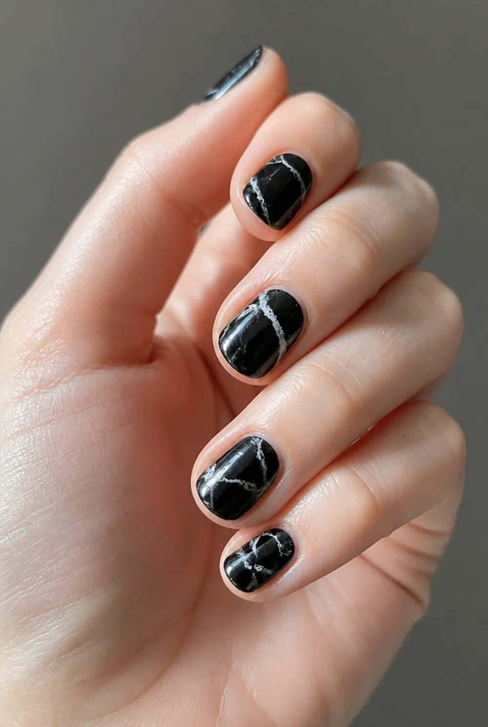 black marquina nail art on fair skin, short length