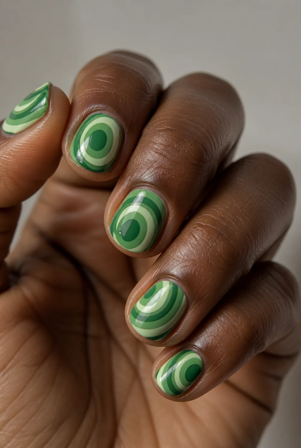 green malachite nail art on deep brown skin