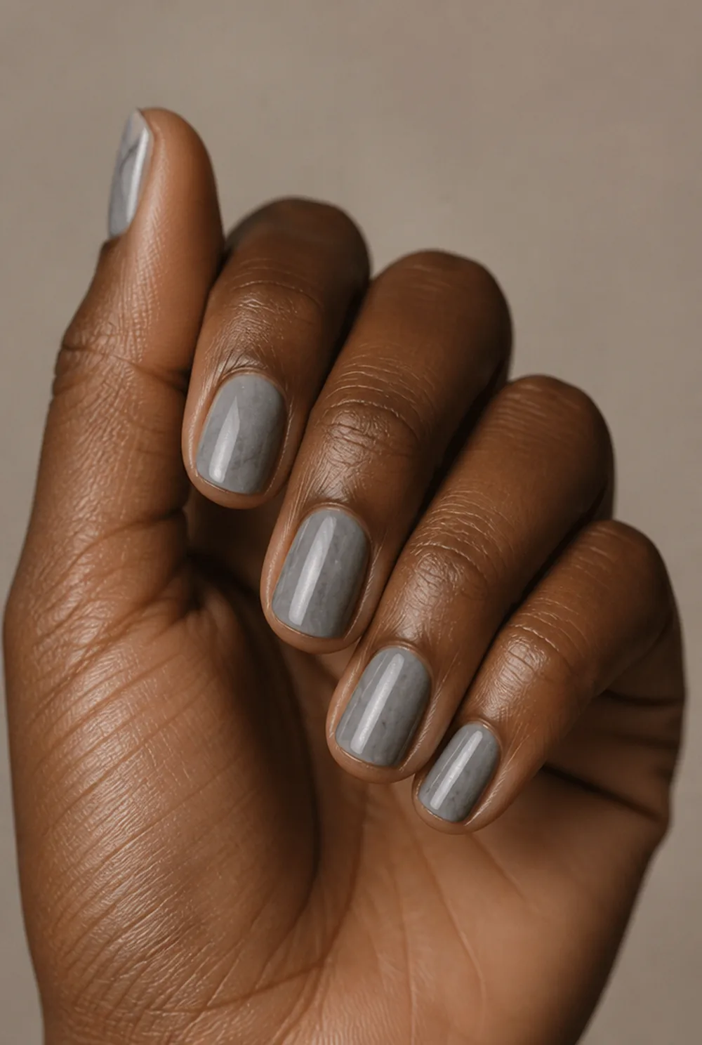 grey marble nail art on deep brown skin