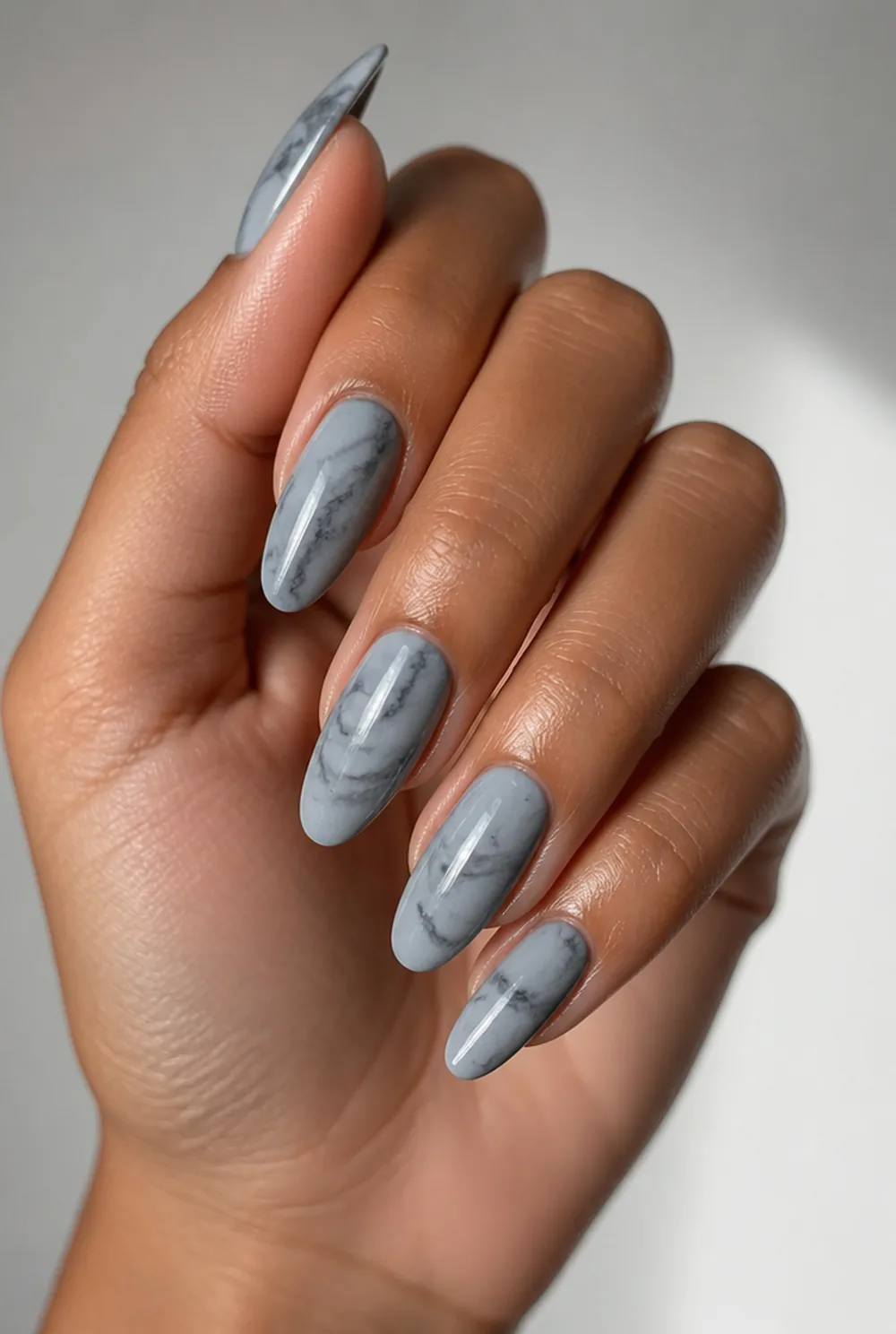 grey marble nail art on olive skin, long length